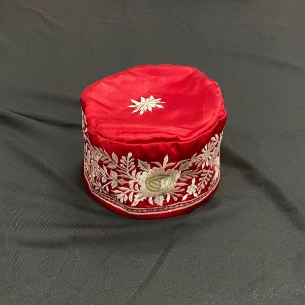 red topi with flower design
