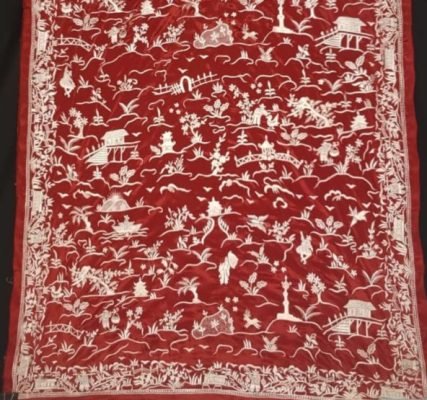 A vibrant red Parsi Gara saree with the China-Chine pattern meticulously hand-embroidered in contrasting white thread.